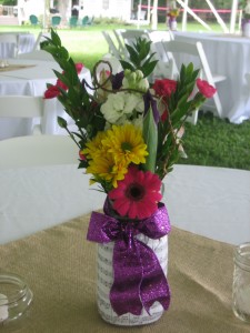 Canning jars were covered with sheet music and filled with assorted flowers to carry out the musical theme of the affair.