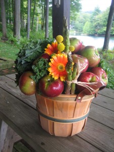 Vegetables joined the apples and flowers in some baskets.