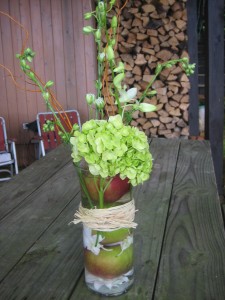 Other tables had these cylinder vases with submerged apples and orchids along with green hydrangeas as their centerpiece.