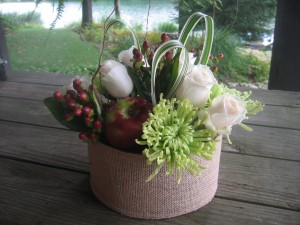 Fugi mums, white roses, and hypernicum berries joined macintosh apples in these table centerpieces.