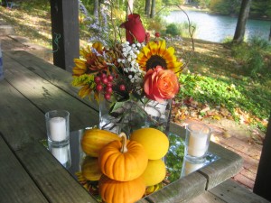 Pumpkins carried out the autumn theme along with fall colored flowers on the tables.