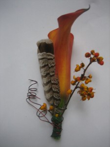 Groomsmen wore orange calla lilies with bittersweet and grouse feathers.