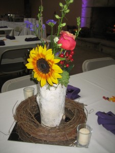 Hollowed out birch logs held flowers on other tables.