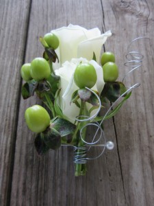 The boutonnieres were made of roses with green hypernicum berries.