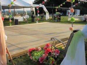 The reception took place outdoors with a dance floor accented with lights and paper flowers.