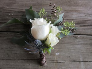 Thistle, roses, and seeded eucalyptus were used for boutonnieres and corsages.