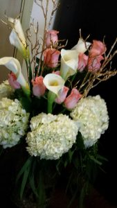Large vases of giant calla lilies, roses and hydrangea decorated the wedding venue.