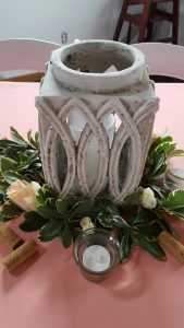 Lanterns surrounded by pittosporum and roses decorated the tables.