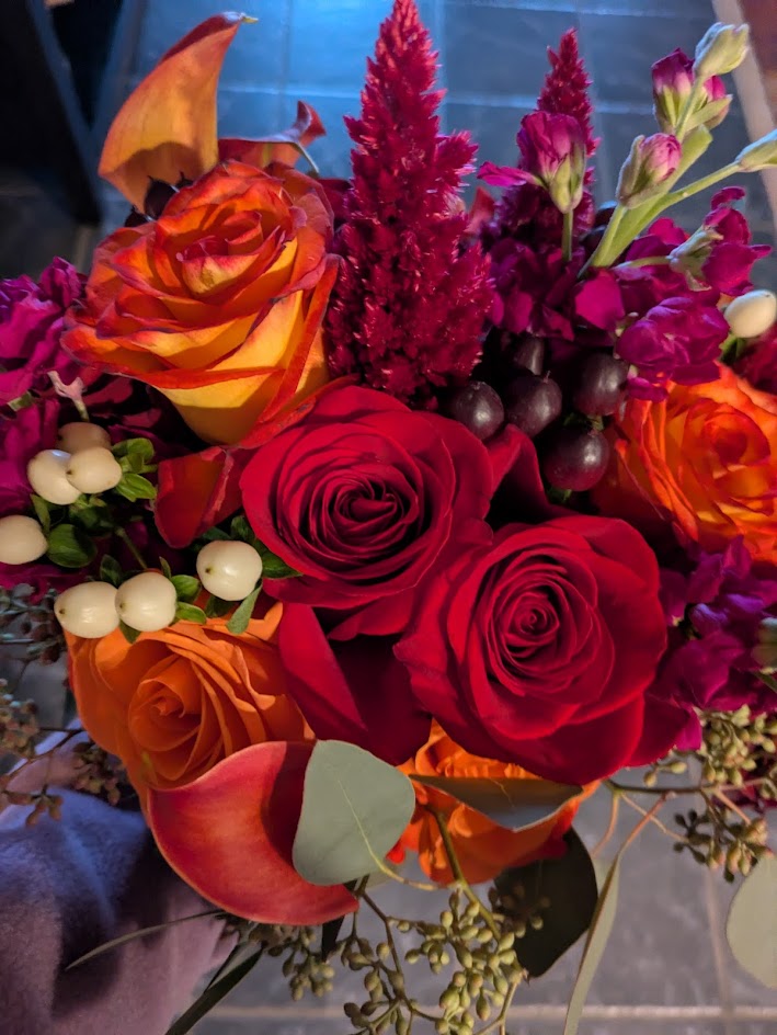 Bright flowers matched their crimson dresses.